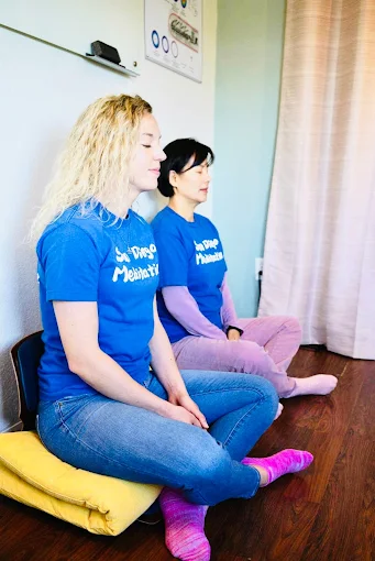 Lauren and Jin, meditation guides at San Diego Meditation Center, practicing guided meditation together